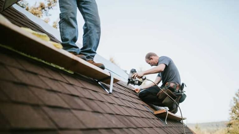 Roofing contractors serving CT inspecting a residential roof
