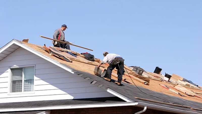 Roofing service in Sarasota with a professional inspecting a residential roof